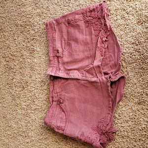 High rise maroon jean shorts with floral application.